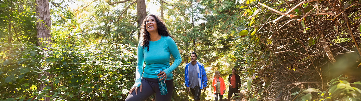 A group of coaches walking along a trail in the woods