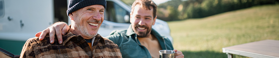 Two men smiling in morning light outdoors